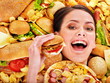 Woman eating hot dog.