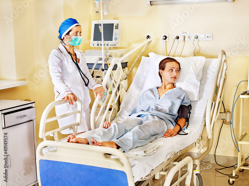 Photo: Doctor treats patient with defibrillator. Doctor treats patient with defibrillator.