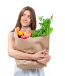 Foto: young woman holding a paper shopping bag full of groceries young woman holding a paper shopping bag full of groceries