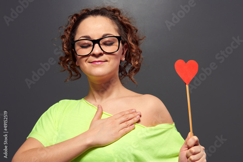 Photo: woman in glasses with red heart woman in glasses with red heart