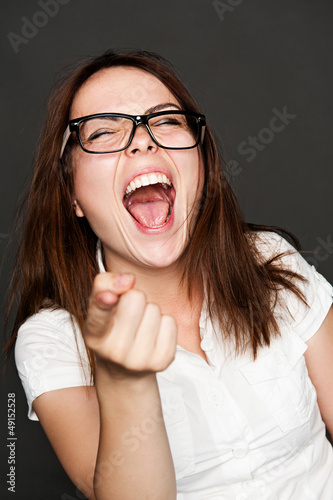 Photo: woman pointing finger and laughing woman pointing finger and laughing
