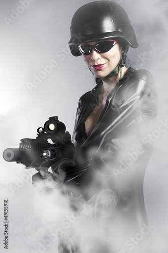 Photo: Sexy woman holding gun with smoke Sexy woman holding gun with smoke