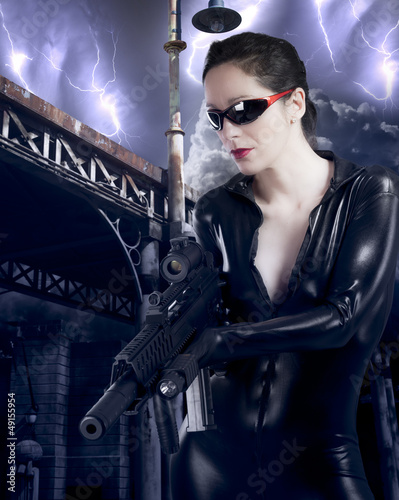 Photo: Young holding a machine gun over gangster background Young holding a machine gun over gangster background