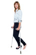 Photo: Pensive looking woman using crutches to walk Pensive looking woman using crutches to walk
