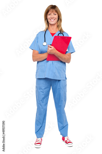 Photo: Smiling confident doctor holding clipboard Smiling confident doctor holding clipboard