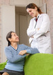 friendly doctor talks with happy mature woman