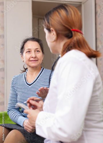 Photo: mature woman complaining to doctor mature woman complaining to doctor