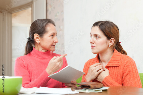 Photo: mother scolds daughter for payments bills or credits mother scolds daughter for payments bills or credits