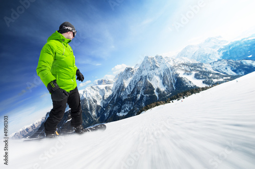Photo: Snowboarder on piste in high mountains Snowboarder on piste in high mountains