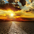 asphalt road and dramatic sunset over it