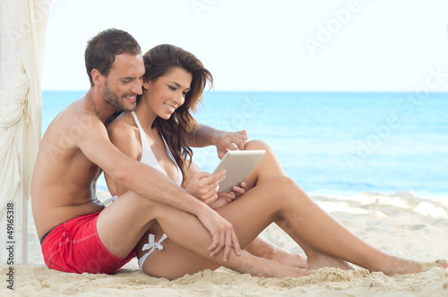 Photo: Happy Couple With Digital Tablet Happy Couple With Digital Tablet