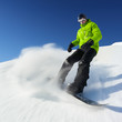 Snowboarder on pise in high mountains