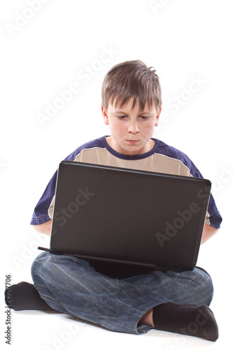 Photo: teenage boy with a laptop teenage boy with a laptop