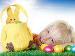 Cute blonde child is happy to have her Easter baskets