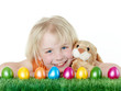 Cute blonde child is happy to have her Easter eggs and bunny