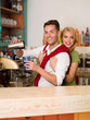 happy couple prepaing a drink