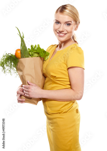 Photo: Young woman with a grocery shopping bag. Isolated on white backg Young woman with a grocery shopping bag. Isolated on white backg