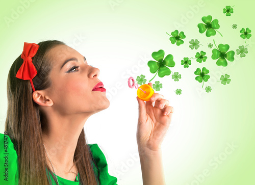 Photo: Beautiful woman making four leaf clover bubbles Beautiful woman making four leaf clover bubbles