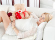 pregnant girl hugging a teddy bear
