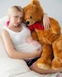 pregnant girl hugging a teddy bear