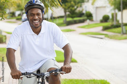 Photo: African American Man Riding Bicycle African American Man Riding Bicycle