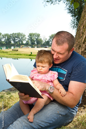 Photo: Father and little girl reading book Father and little girl reading book