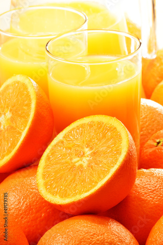 Photo: Composition with two glasses of orange juice and fruits Composition with two glasses of orange juice and fruits