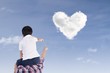 Father and son watch heart clouds
