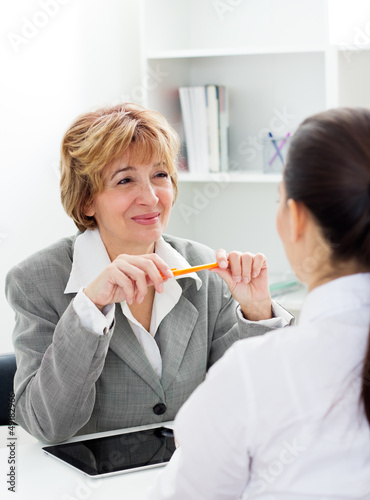 Photo: Young woman having a job interview Young woman having a job interview