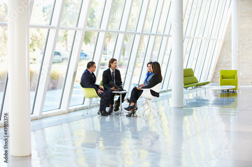 Photo: Business people Having Meeting In Modern Office Business people Having Meeting In Modern Office