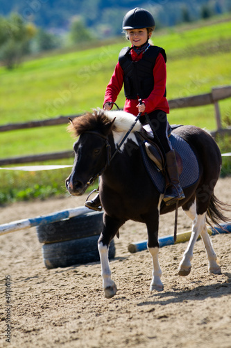 Photo: Horse riding - lovely equestrian on a pony Horse riding - lovely equestrian on a pony