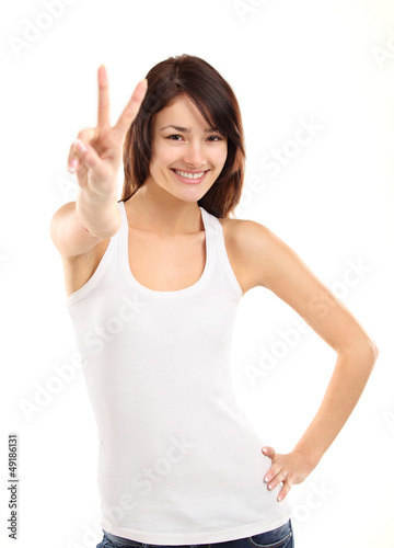 Photo: Portrait of a pretty young woman showing the peace sign Portrait of a pretty young woman showing the peace sign