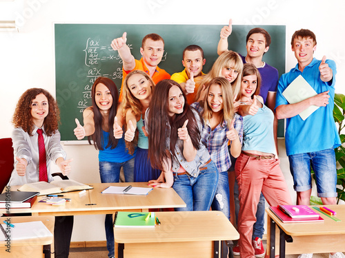 Photo: Group student in classroom near blackboard. Group student in classroom near blackboard.