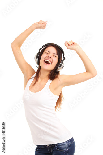 Photo: Woman with headphones listening music on player Woman with headphones listening music on player