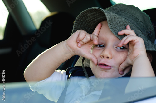 Photo: Mischievous little boy gesturing at the camera Mischievous little boy gesturing at the camera