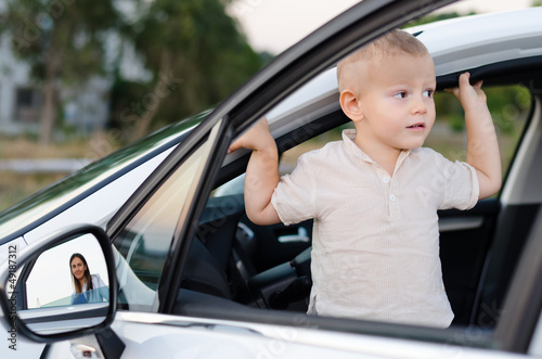 Photo: Little boy in an open car door Little boy in an open car door