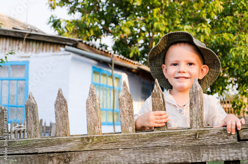 Photo: Beaming little boy in a summer sunhat Beaming little boy in a summer sunhat