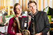 Young couple is buying Tracht or dirndl in a shop