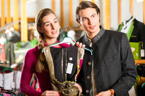 Photo: Young couple is buying Tracht or dirndl in a shop Young couple is buying Tracht or dirndl in a shop