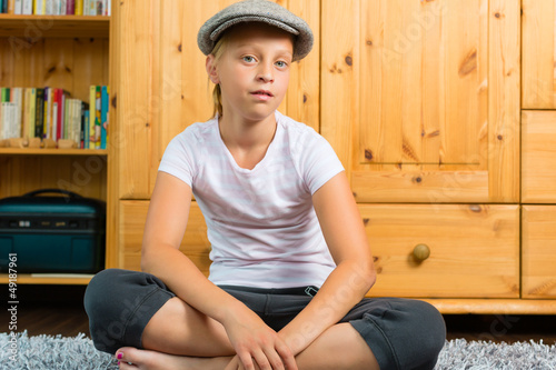 Photo: Family - child sitting with cap in room Family - child sitting with cap in room