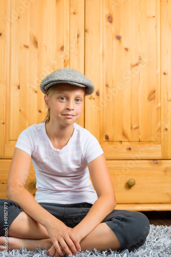 Photo: Family - child sitting with cap in room Family - child sitting with cap in room