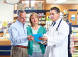 Pharmacist with a senior couple.