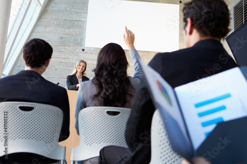 Photo: Businesswoman Delivering Presentation At Conference Businesswoman Delivering Presentation At Conference
