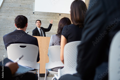 Photo: Businessman Delivering Presentation At Conference Businessman Delivering Presentation At Conference