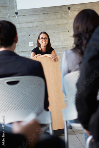Photo: Businesswoman Delivering Presentation At Conference Businesswoman Delivering Presentation At Conference