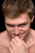 Young man with a malicious grin