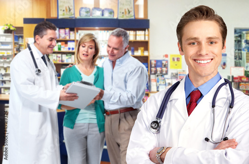 Photo: Pharmacist with a senior couple. Pharmacist with a senior couple.