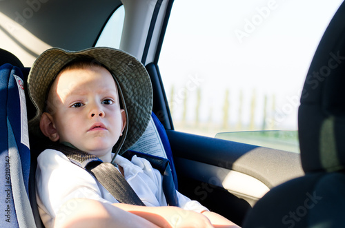 Photo: Cute little boy passenger in a car Cute little boy passenger in a car