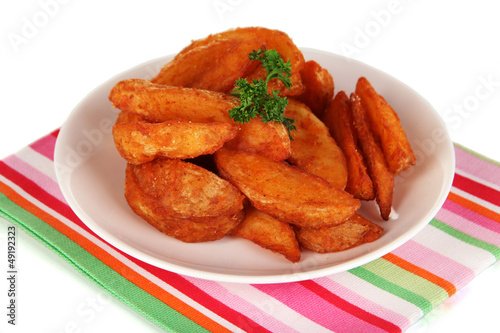 Photo: Appetizing village potatoes on plate isolated on white Appetizing village potatoes on plate isolated on white