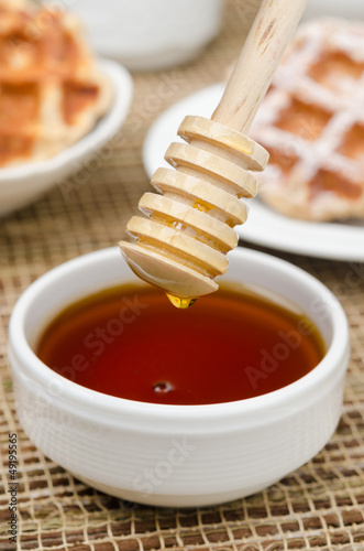 Photo: Bowl of honey with wooden dipper Bowl of honey with wooden dipper